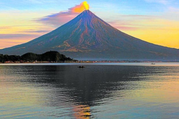 Mt. Mayon is a picture of beauty and calm at daybreak on Sunday in this photo taken from Barangay Puro, Legazpi City. But the volcano is actually under alert level 1, or exhibiting abnormal condition, and has entered a period of unrest where chances of sudden steam-driven eruption can occur without warning, government volcanologists say. STORY: Mayon shows faint crater glow