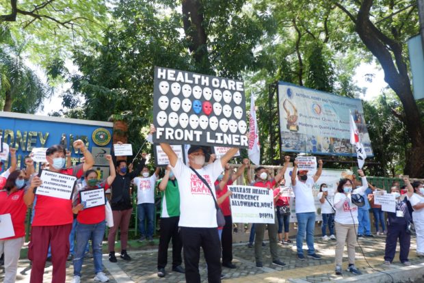 Members of the Alliance of Health Workers stage a protest in Quezon City to call the government's attention to the alleged delay in the health workers' benefits from the One COVID-19 Allowance