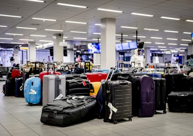 This photograph taken on July 26, 2022 shows suitcases at the baggage claim service at Schiphol Airport in Amsterdam.