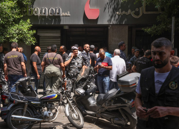 Members of Lebanese police and civil defence secure the area outside Federal bank in Hamra, Lebanon August 11, 2022. 