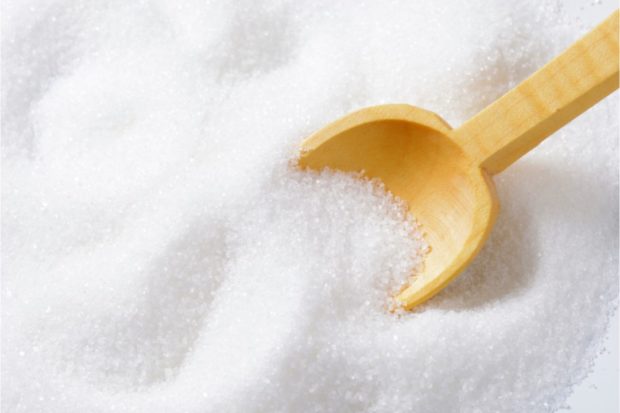 Stock image of sugar with a wooden spoon. STORY: Gov’t to sell smuggled sugar through Kadiwa