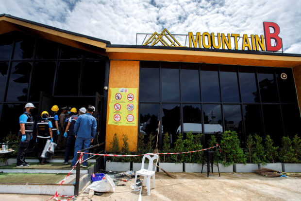 Forensic officers enter the Mountain B nightclub where at least 13 people were killed and 35 injured when a fire broke out early on Friday, in Chonburi province, Thailand, August 5, 2022. REUTERS/Tanat Chayaphattharitthee