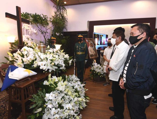 Former President Rodrigo R. Duterte with Senator Bong Go offer their prayers  in front of the urn of Former President Fidel V Ramos.