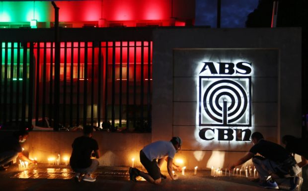 Photo of ABS-CBN employees lighting candles in solidarity as the network’s darkest hour came in May 2020 for story: ABS-CBN’s TeleRadyo shuts down on June 30