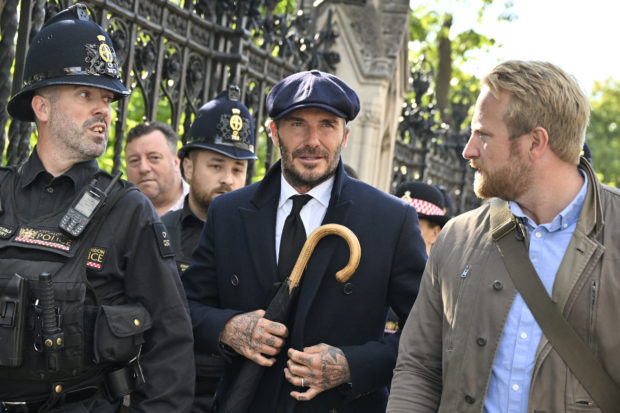 English former football player David Beckham leaves Westminster Hall, at the Palace of Westminster, in London on September 16, 2022 after paying his respects to the coffin of Queen Elizabeth II as it Lies in State. - Queen Elizabeth II will lie in state in Westminster Hall inside the Palace of Westminster, until 0530 GMT on September 19, a few hours before her funeral, with huge queues expected to file past her coffin to pay their respects. (Photo by Louisa Gouliamaki / AFP)