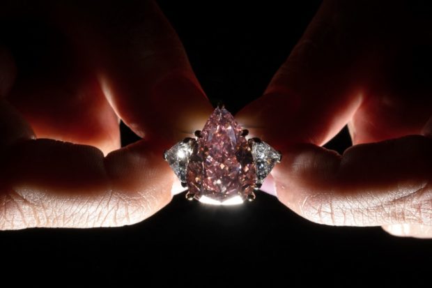 A picture taken in Geneva on September 23, 2022 shows the Fortune Pink, an exceptionally rare giant gemstone, that is expected to bring in up to $35 million when it will comes up for sale in Geneva on November 8, 2022 by Christie's auction house. - At over 18 carats, the vividly coloured gem is the largest pear-shaped pink diamond of its quality ever to be offered for sale at auction. (Photo by Fabrice COFFRINI / AFP)