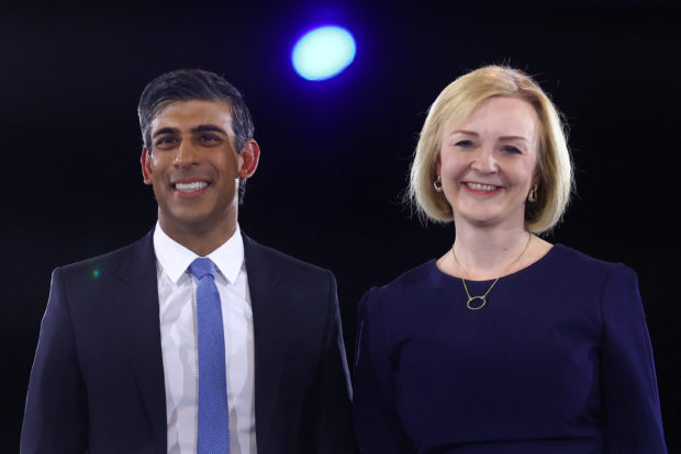 FILE PHOTO: Conservative leadership candidates Liz Truss and Rishi Sunak stand together as they attend a hustings event, part of the Conservative party leadership campaign, in London, Britain August 31, 2022. REUTERS/Hannah McKay/File Photo