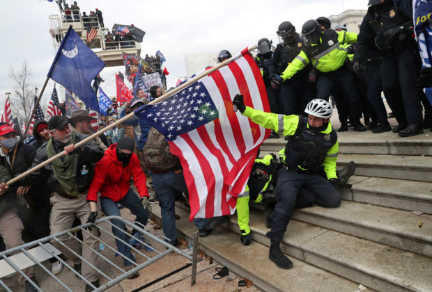 FILE PHOTO: Members of U.S. Capitol Police try to fend off a mob of supporters of U.S. President Donald Trump as one of them tries to use a flag like a spear as the supporters storm the U.S. Capitol Building in Washington, U.S., January 6, 2021. Picture taken January 6, 2021. REUTERS/Leah Millis
