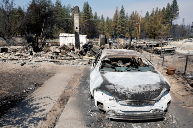 A burned car stands amid debris in the aftermath of the Mill Fire, in Weed, California, U.S., September 3, 2022. REUTERS/Fred Greaves