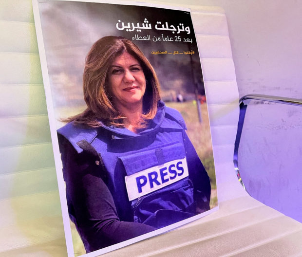 FILE PHOTO: A picture of Al Jazeera reporter Shireen Abu Akleh, who was killed during an Israeli raid in Jenin, is displayed at the Al-Jazeera headquarters building in Doha, Qatar, May 11, 2022. REUTERS/Imad Creidi