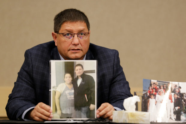 Mark Arcand, brother of Bonnie Burns, who was killed on Sunday at James Smith Cree Nation, holds up a photo of them at a news conference in Saskatoon, Saskatchewan, Canada, September 7, 2022. REUTERS/Valerie Zink