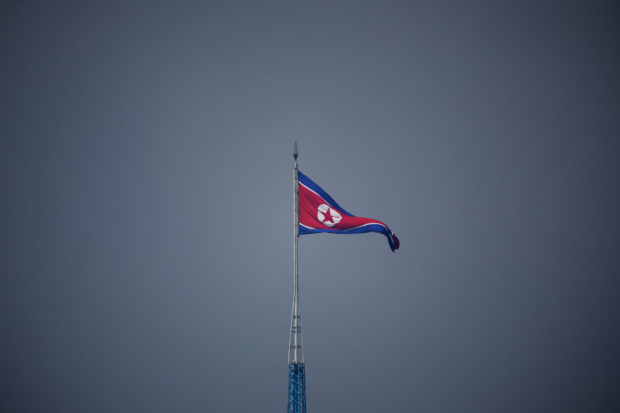 FILE PHOTO: A North Korean flag flutters at the propaganda village of Gijungdong in North Korea, in this picture taken near the truce village of Panmunjom inside the demilitarized zone (DMZ) separating the two Koreas, South Korea, July 19, 2022.    REUTERS/Kim Hong-Ji/Pool