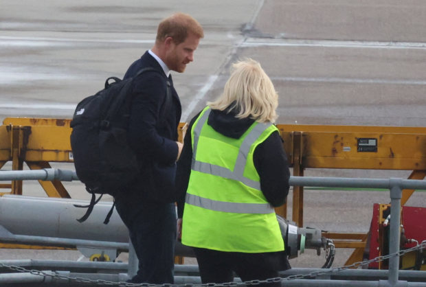 Britain's Prince Harry boards a plane at Aberdeen International Airport, following the passing of Britain's Queen Elizabeth, in Aberdeen, Britain, September 9, 2022. REUTERS/Phil Noble