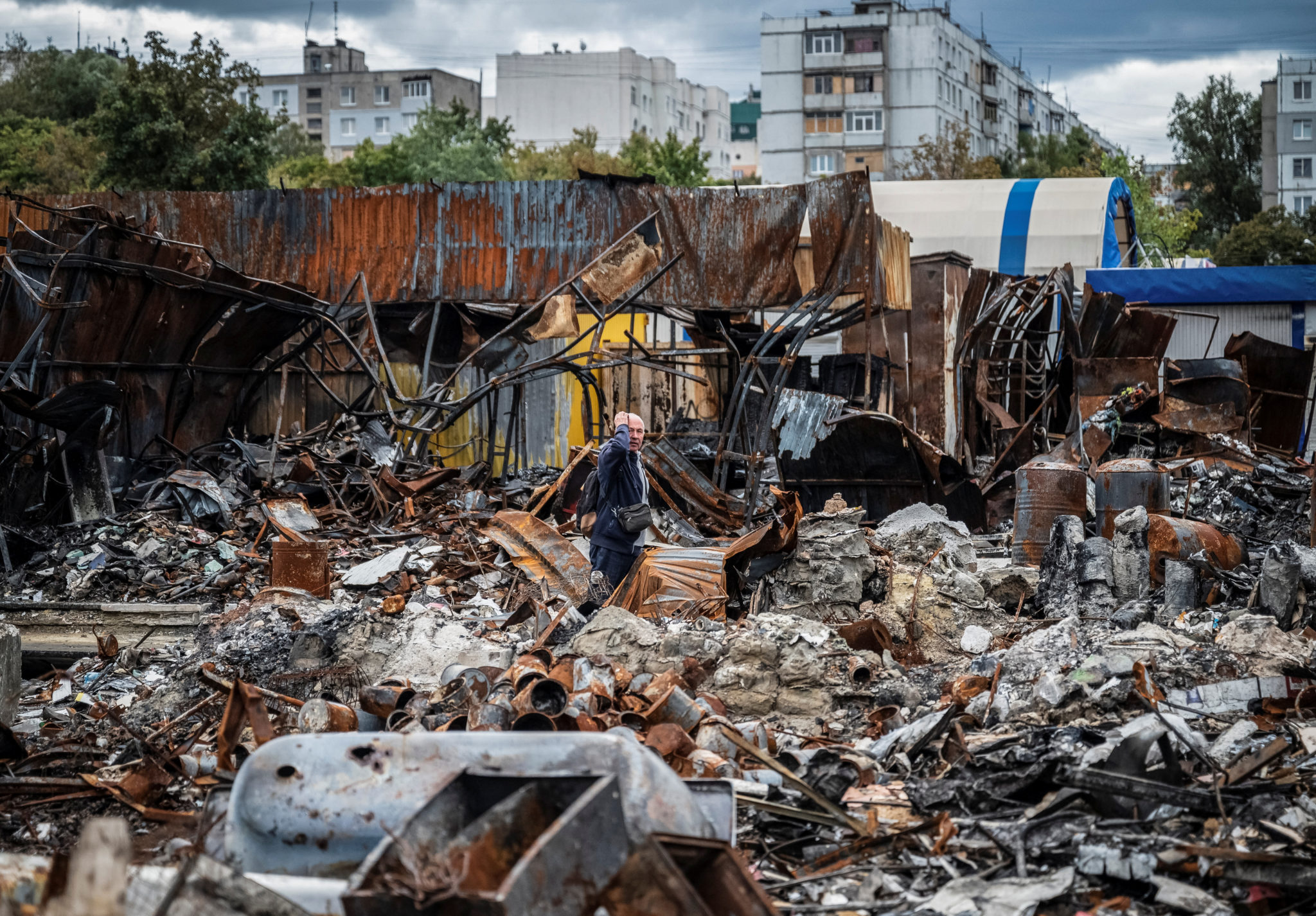 FILE PHOTO: A local resident walks by a street market destroyed by military strikes, as Russia's invasion of Ukraine continues, in Saltivka, one of the most damaged residential areas of Kharkiv, Ukraine September 6, 2022. REUTERS/Viacheslav Ratynskyi