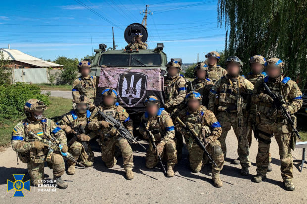 Service members of the State Security Service of Ukraine pose for a picture in the recently liberated town of Kupiansk, amid Russia's attack on Ukraine, in Kharkiv region, Ukraine in this handout picture released September 10, 2022. Press Service of the State Security Service of Ukraine/Handout via REUTERS