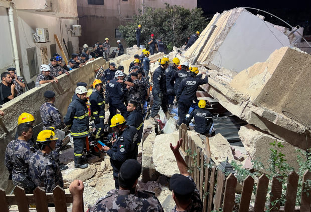 Civil defense members work at the site of a four-storey residential building collapse in Amman, Jordan September 13, 2022. REUTERS/Jehad Shelbak