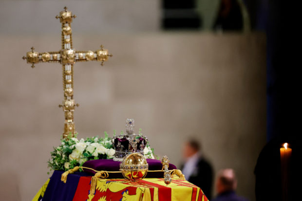 A view of Queen Elizabeth's coffin, draped in the Royal Standard, with the Imperial State Crown and flowers on top, following her death, during her lying-in-state at Westminster Hall, in London, Britain, September 18, 2022. REUTERS/Sarah Meyssonnier/Pool