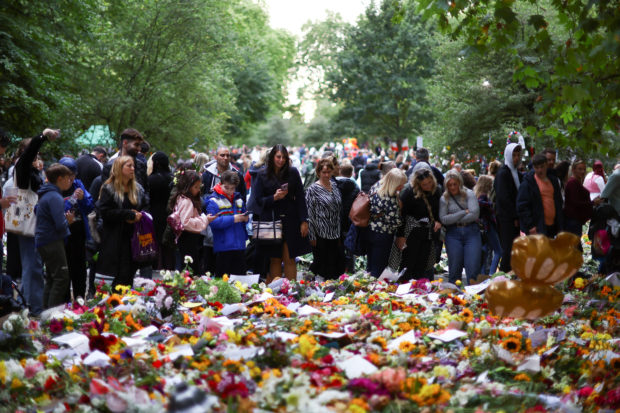 People view floral tributes in Green Park, following the death of Britain's Queen Elizabeth, in London, Britain, September 18, 2022. REUTERS/Hannah McKay