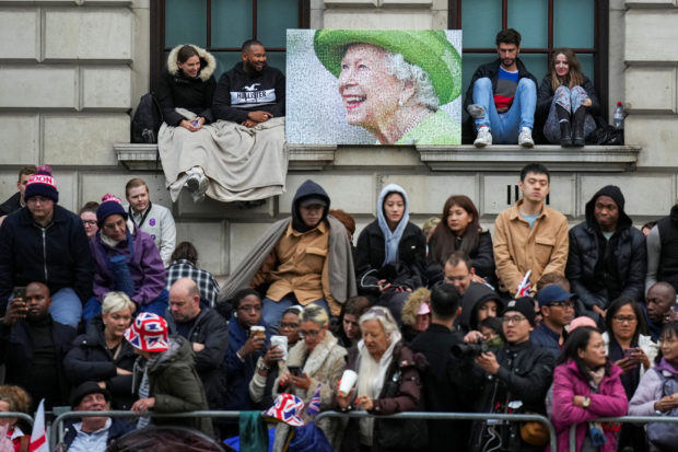 Tens of thousands of people, many of whom had camped out overnight, lined the route of Queen Elizabeth's funeral procession