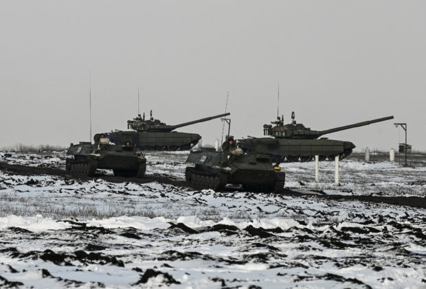 Russian army service members drive MT-LB multi-purpose amphibious armoured carriers past tanks during drills at the Kuzminsky range in the southern Rostov region, Russia January 26, 2022. REUTERS/Sergey Pivovarov