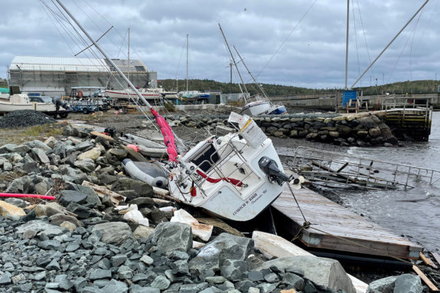 A sailboat lies washed up on shore following the passing of Hurricane Fiona, later downgraded to a post-tropical storm, in Shearwater, Nova Scotia, Canada September 24, 2022.  REUTERS/Eric Martyn