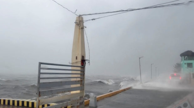 Waves crashes into road on coastline during heavy storm in Polillo, Quezon Province, Philippines September 25, 2022 in this still image obtained from a video. Lgu Polillo Handout/via REUTERS