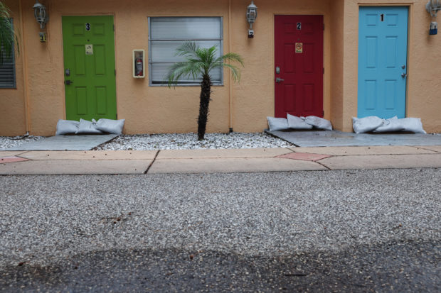 Sandbags sit outside door fronts, as Hurricane Ian spun toward the state carrying high winds, torrential rains and a powerful storm surge, in the beachside community of Indian Shores, Florida, U.S., September 27, 2022. REUTERS/Shannon Stapleton