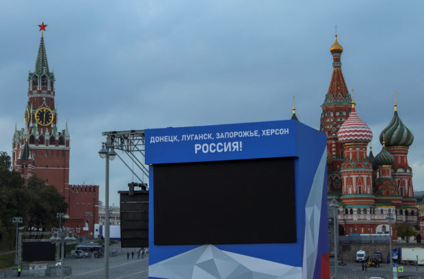 A view shows a screen, set up ahead of an expected ceremony and concert to declare four Ukraine's self-proclaimed regions part of Russia following recent referendums, near St. Basil's Cathedral and the Kremlin's Spasskaya Tower in central Moscow, Russia September 29, 2022. A slogan on the screen reads: "Donetsk, Luhansk, Zaporizhzhia, Kherson - Russia!"  REUTERS/Evgenia Novozhenina