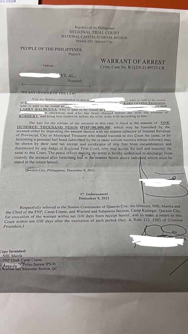 The arrest warrant served to UP Diliman student activist Kara Taggaoa and labor leader Larry Valbuena for robbery charges