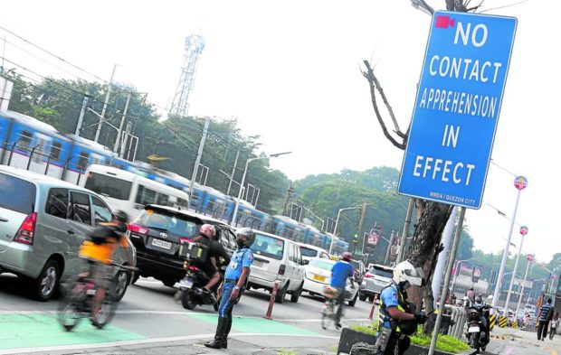 "No contact apprehension in effect” sign on a street. STORY: NCAP suspended, but earlier fines stand – MMDA