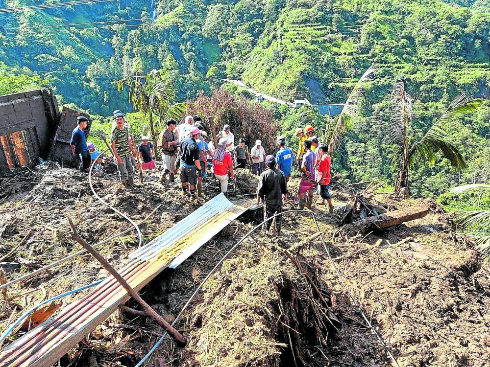Rescue personnel respond to a landslide in Mayoyao town in Ifugao province where a farmer was killed