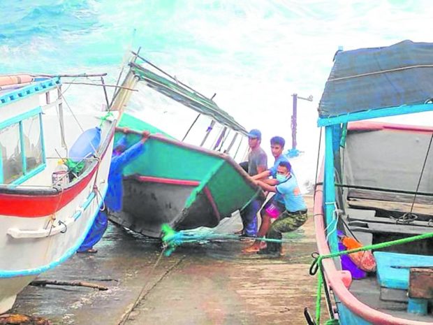  Villagers in Itbayat town, Batanes province, secure their boats on Friday in anticipation of tidal surges as Typhoon “Henry” (international name: Hinnamnor) lashes Northern Luzon. Authorities have confirmed one typhoon fatality, a farmer who died in a landslide in Mayoyao, Ifugao. —Photos from Itbayat police