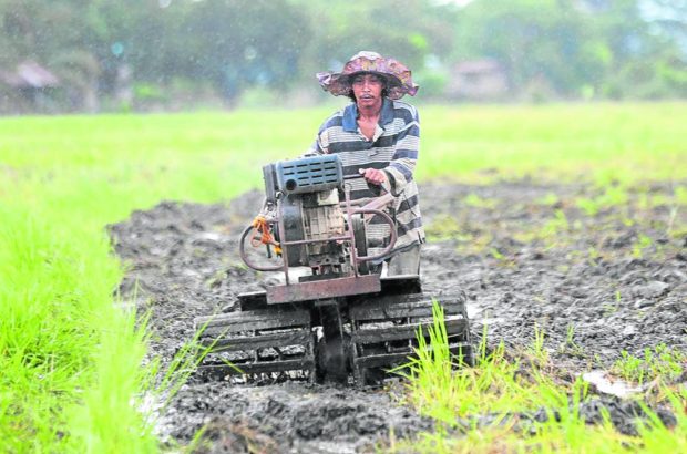 Farmer with a hand-operated tractor. STORY: EO suspends loan payments of land reform beneficiaries