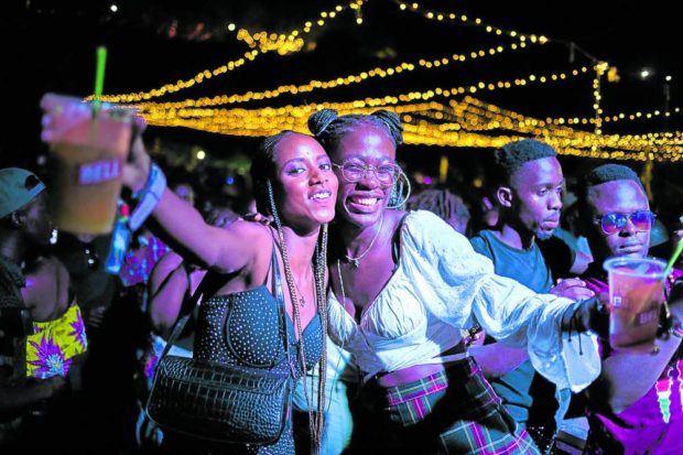 Revelers pose with drinks at the Nyege Nyege music festival which ended on Sunday. Amid claims that the event promoted sex, homosexuality and drug use, Ugandan authorities reversed an earlier ban following a public outcry. STORY: ‘Immoral’ music festival draws sold-out crowds