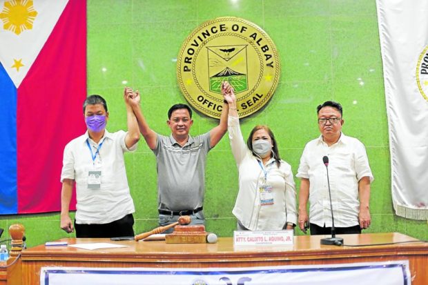 VICTORY BUMP In this photo taken shortly after the May 9 elections, then Legazpi City Mayor Noel Rosal (second from left) is proclaimed governor of Albay. But after almost three months in office, Rosal is fighting off a disqualification case linked to the release of cash aid during his term as mayor. —GEORGE GIO BRONDIAL