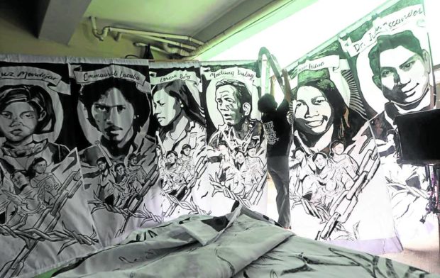 REMEMBER THE FALLEN Portraits of slain anti-Marcos activists, being prepared here on Tuesday by the human rights watchdog Karapatan, form part of today’s cultural program at the University of the Philippines marking the 50th anniversary of the declaration of martial law.—NIÑO JESUS ORBETA