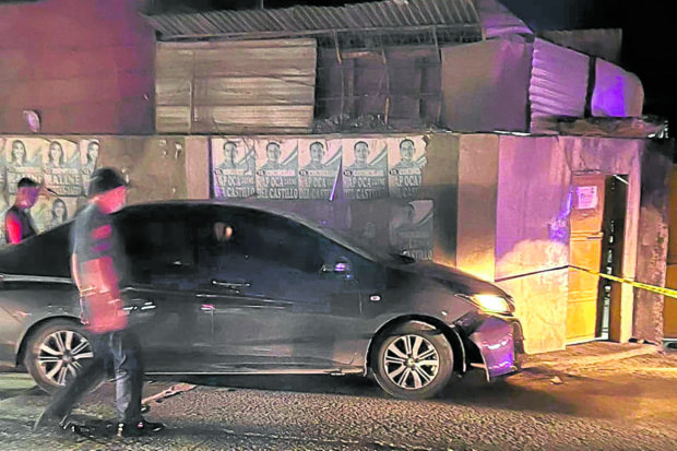 A policeman inspects the car of lawyer Karen Quiñanola Gonzales after she and her son were shot and wounded by two men in Mandaue City