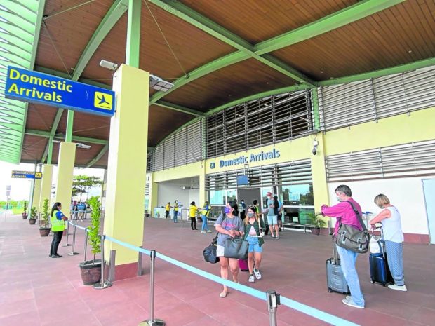 Travelers who arrive at the Bohol-Panglao International Airport, like these passengers on Friday, are no longer required to present their COVID-19 vaccination cards 