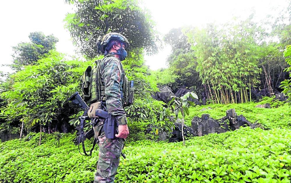  A battle-ready policeman surveys the conservation site