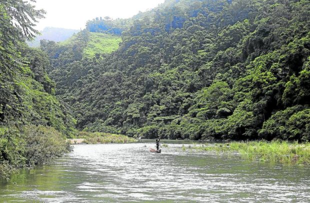 ANCESTRAL ABODE  Members of the Dumagat indigenous peoples group, like this tribesman sailing on a raft in Kaliwa-Kaliwa River in Infanta, Quezon province, consider Sierra Madre as their ancestral home. —RICHARD A. REYES