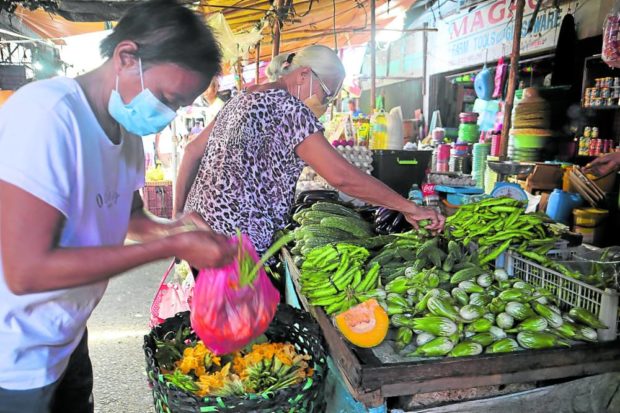 People at the market. STORY: DTI freezes prices in 6 provinces hit by Karding