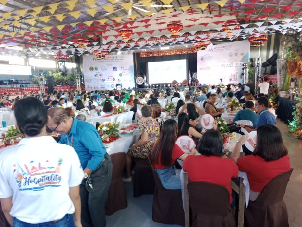Delegates of 31st Mindanao Business Conference in Tandag City have to contend with hand fans amid the humid condition inside the North Eastern Mindanao State University. CHRIS V. PANGANIBAN