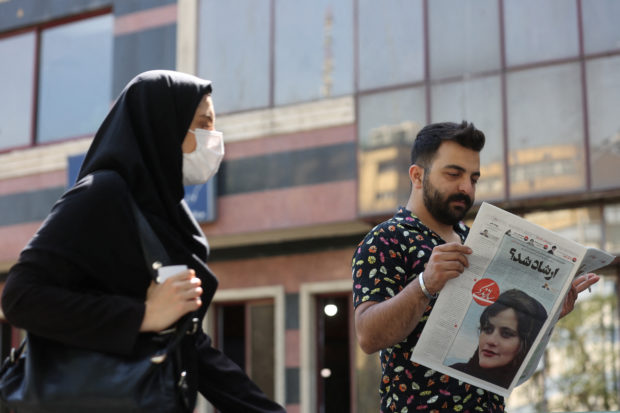 Newspapers with Amini, a victim of country's "morality police", are seen in Tehran