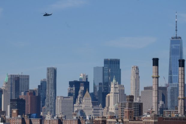 A helicopter flies above the city skyline of New York on June 10, 2022.