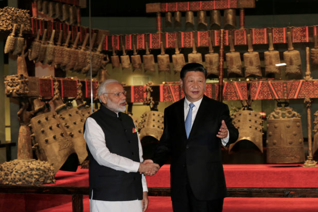 FILE PHOTO: Chinese President Xi Jinping and Indian Prime Minister Narendra Modi visit the Hubei Provincial Museum in Wuhan
