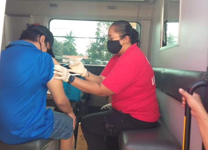 n employee of the Angeles City government administers a booster shot to a resident of Mabalacat City