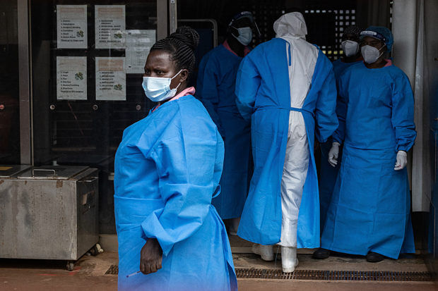 Members of the Ugandan Medical staff of the Ebola Treatment Unit stand inside the ward in Personal Protective Equipment (PPE) at Mubende Regional Referral Hospital in Uganda on September 24, 2022. - On September 20, 2022, the health authorities in Uganda declared an outbreak of Ebola after a case of the Sudan ebolavirus was confirmed in the Mubende district and registering three deaths including a 12-years-old girl. (Photo by BADRU KATUMBA / AFP)