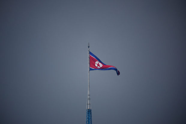 A North Korean flag flutters at the propaganda village of Gijungdong in North Korea, in this picture taken near the truce village of Panmunjom inside the demilitarized zone (DMZ) separating the two Koreas, South Korea, July 19, 2022. REUTERS/Kim Hong-Ji/Pool/Files