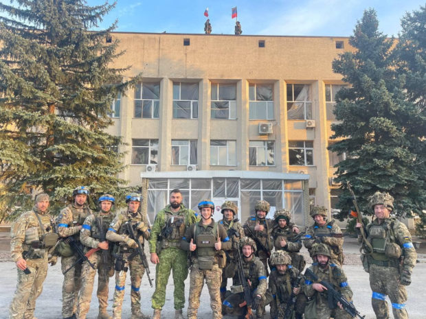 Ukrainian troops pose for a photo in Lyman, Ukraine in this picture released in social media October 1, 2022. Courtesy of Oleksiy Biloshytskyi/via REUTERS