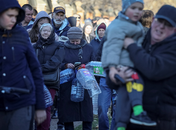 Local residents queue for water after a Russian missile attack in Kyiv. STORY: Russia hits Ukrainian hydropower plants in new missile strikes